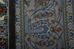 Backside of handmade 2000s Kashan rug showing knot structure and weave density