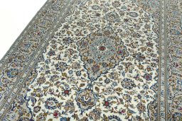 Backside of handmade 2000s Kashan rug showing knot structure and weave density