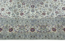 Corner detail of 2000s Kashan rug showing border pattern and Wool pile
