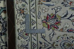 Backside of handmade 2000s Kashan rug showing knot structure and weave density