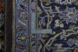 Backside of handmade 2000s Kashan rug showing knot structure and weave density