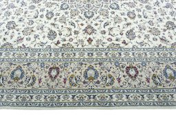 Corner detail of 2000s Kashan rug showing border pattern and Wool pile