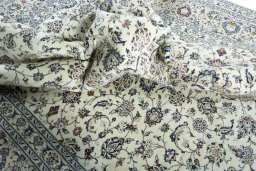 Surface texture of 2000s Kashan rug with natural Wool and intricate pattern
