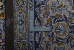 Backside of handmade 1970s Kashan rug showing knot structure and weave density
