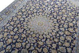 Backside of handmade 1970s Kashan rug showing knot structure and weave density