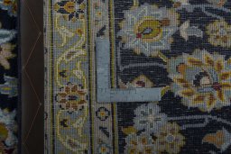 Backside of handmade 1970s Kashan rug showing knot structure and weave density