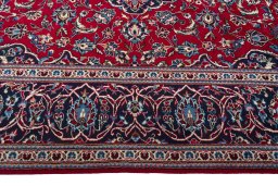 Corner detail of 2000s Kashan rug showing border pattern and Wool pile