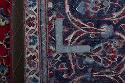 Backside of handmade 2000s Kashan rug showing knot structure and weave density