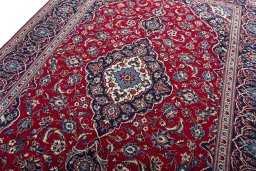 Backside of handmade 2000s Kashan rug showing knot structure and weave density