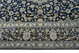 Corner detail of 2000s Kashan rug showing border pattern and Wool pile