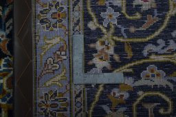 Backside of handmade 2000s Kashan rug showing knot structure and weave density
