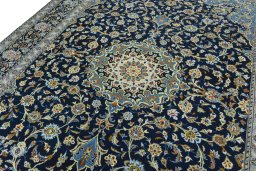 Backside of handmade 2000s Kashan rug showing knot structure and weave density