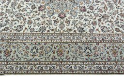 Corner detail of 2000s Kashan rug showing border pattern and Wool pile
