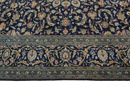 Corner detail of 2000s Kashan rug showing border pattern and Wool pile