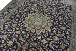 Backside of handmade 2000s Kashan rug showing knot structure and weave density