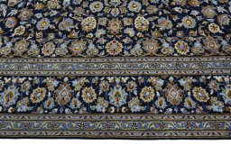 Corner detail of 2000s Kashan rug showing border pattern and Wool pile