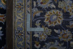 Backside of handmade 2000s Kashan rug showing knot structure and weave density