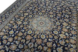 Backside of handmade 2000s Kashan rug showing knot structure and weave density