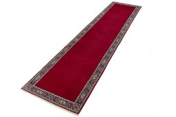 Corner detail of 2000s Kashan rug showing border pattern and Wool pile