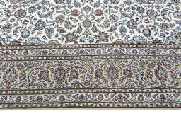 Corner detail of 2000s Kashan rug showing border pattern and Wool pile