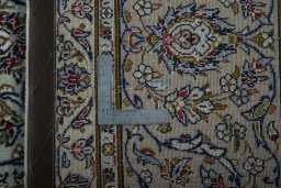 Backside of handmade 2000s Kashan rug showing knot structure and weave density