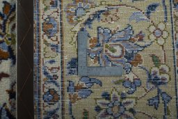 Backside of handmade 1970s Kashan rug showing knot structure and weave density