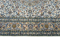 Corner detail of 2000s Kashan rug showing border pattern and Wool pile