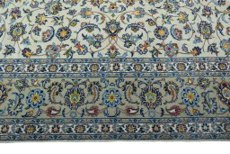 Corner detail of 2000s Kashan rug showing border pattern and Wool pile