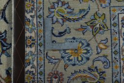 Backside of handmade 2000s Kashan rug showing knot structure and weave density