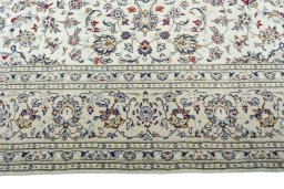 Corner detail of 2000s Kashan rug showing border pattern and Wool pile