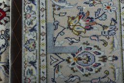 Backside of handmade 2000s Kashan rug showing knot structure and weave density