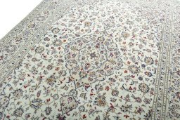 Backside of handmade 2000s Kashan rug showing knot structure and weave density