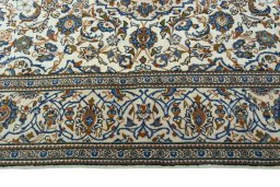 Corner detail of 2000s Kashan rug showing border pattern and Wool pile