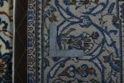 Backside of handmade 2000s Kashan rug showing knot structure and weave density