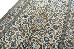 Backside of handmade 2000s Kashan rug showing knot structure and weave density