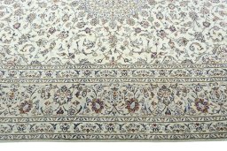 Corner detail of 2000s Kashan rug showing border pattern and Wool pile