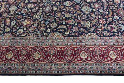 Corner detail of 2000s Kashan rug showing border pattern and Wool pile