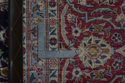Backside of handmade 2000s Kashan rug showing knot structure and weave density