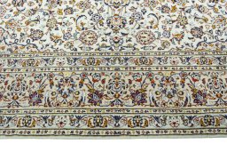 Corner detail of 2000s Kashan rug showing border pattern and Wool pile