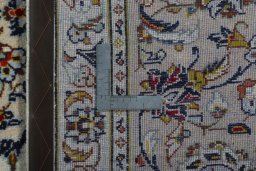 Backside of handmade 2000s Kashan rug showing knot structure and weave density