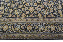 Corner detail of 2000s Kashan rug showing border pattern and Wool pile