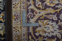 Backside of handmade 2000s Kashan rug showing knot structure and weave density