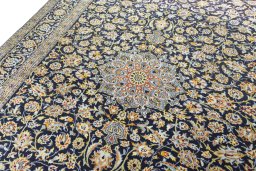Backside of handmade 2000s Kashan rug showing knot structure and weave density