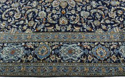Corner detail of 2000s Kashan rug showing border pattern and Wool pile