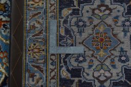 Backside of handmade 2000s Kashan rug showing knot structure and weave density