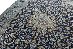 Backside of handmade 2000s Kashan rug showing knot structure and weave density