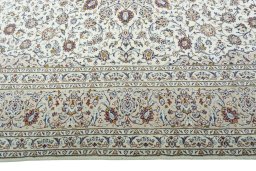 Corner detail of 2000s Kashan rug showing border pattern and Wool pile