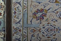 Backside of handmade 2000s Kashan rug showing knot structure and weave density