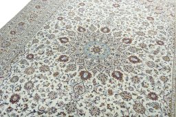 Backside of handmade 2000s Kashan rug showing knot structure and weave density