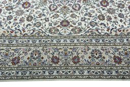 Corner detail of 2000s Kashan rug showing border pattern and Wool pile